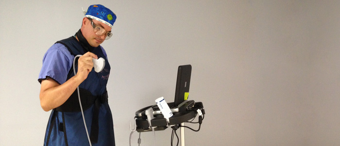 Doctor dressed in our fashionable x-ray protection gear, begins an ultrasound.